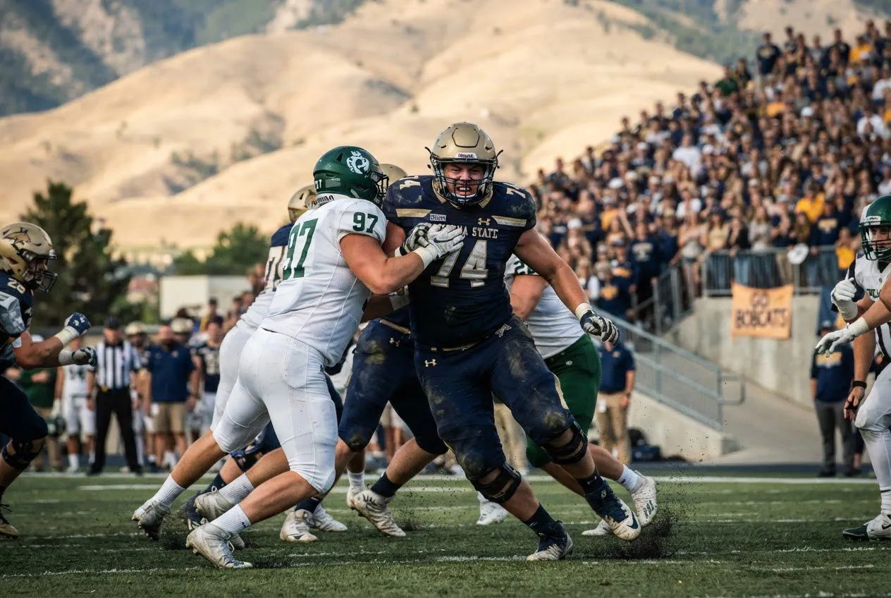 Action shot, eye-level from the sideline at Bobcat Stadium, shot with a 400mm lens.